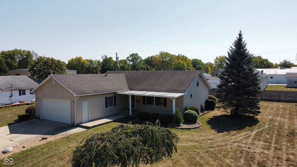 ranch-style house with a garage and a front lawn