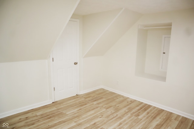 additional living space with lofted ceiling and light hardwood / wood-style floors