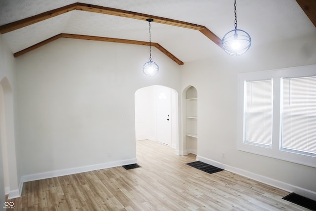 unfurnished room with vaulted ceiling with beams, light hardwood / wood-style flooring, and built in features