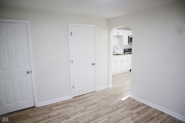 hall featuring light wood-type flooring and sink