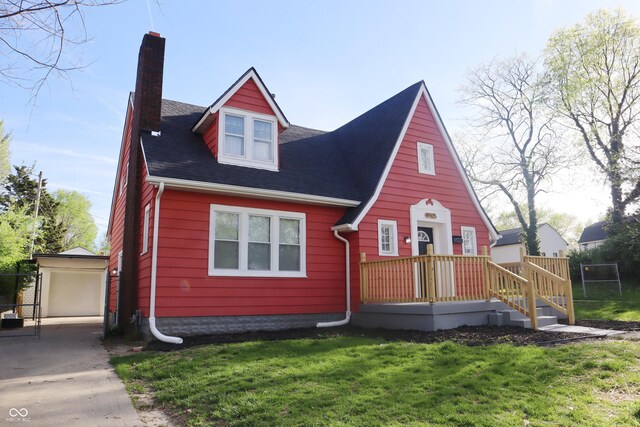 view of front of home with a front lawn, an outdoor structure, and a garage