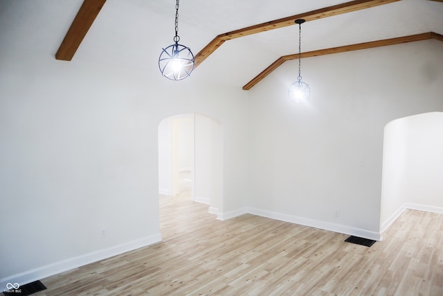 spare room featuring high vaulted ceiling, beam ceiling, and light hardwood / wood-style floors