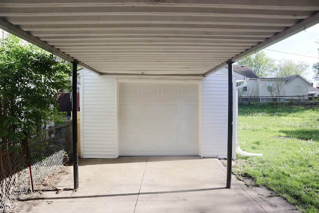 garage with a yard and a carport