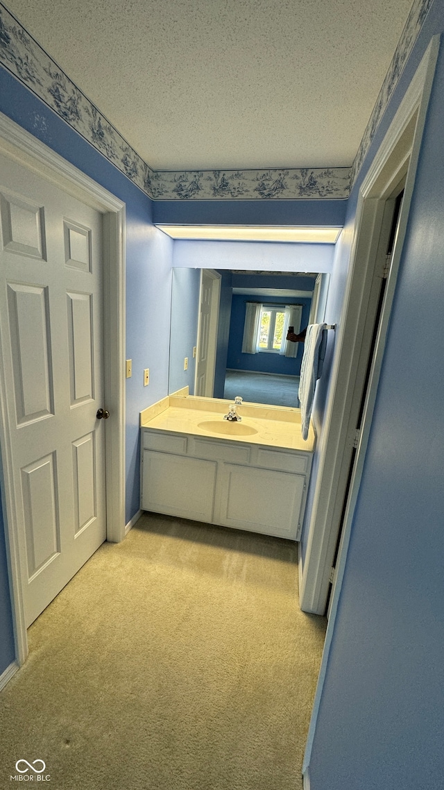 bathroom featuring a textured ceiling and sink