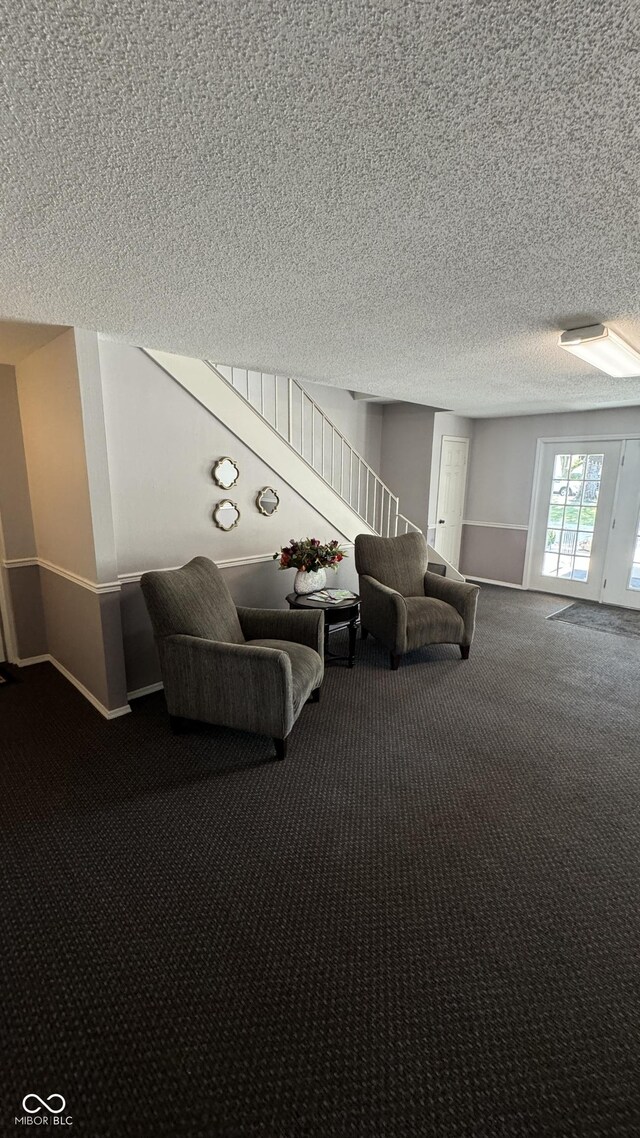 unfurnished room with a textured ceiling and carpet floors