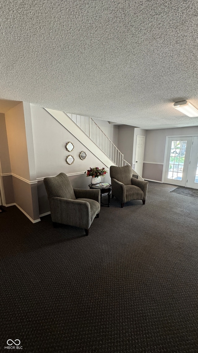 unfurnished room featuring carpet floors and a textured ceiling