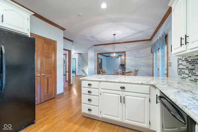 kitchen featuring white cabinets, light hardwood / wood-style flooring, pendant lighting, and black refrigerator