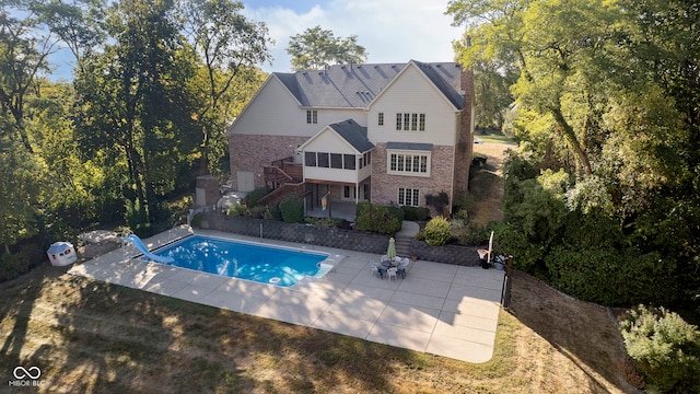 view of swimming pool with a patio and a wooden deck