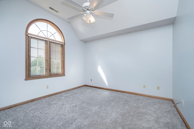 empty room featuring carpet, vaulted ceiling, and ceiling fan