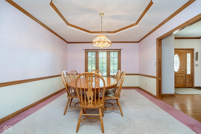 dining space with a chandelier, light hardwood / wood-style floors, and crown molding