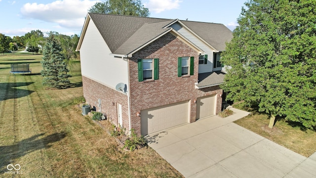 view of front of house featuring central AC, a front yard, and a garage