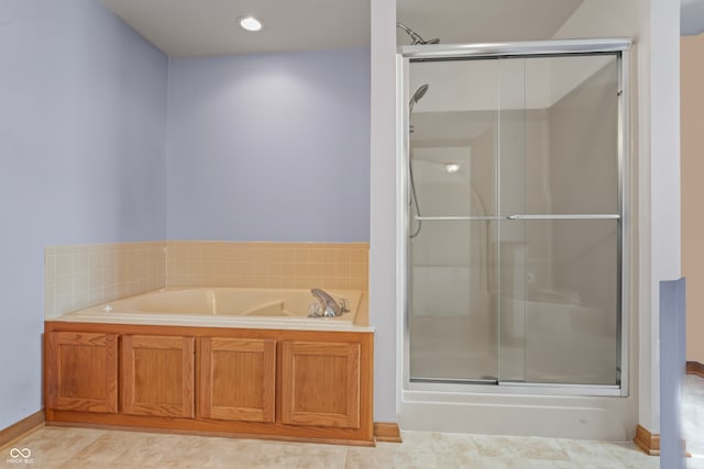 bathroom featuring tile patterned flooring and independent shower and bath