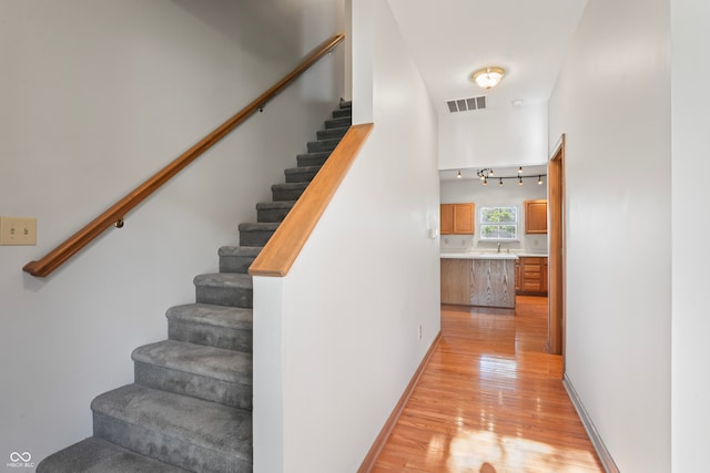 stairs with hardwood / wood-style floors