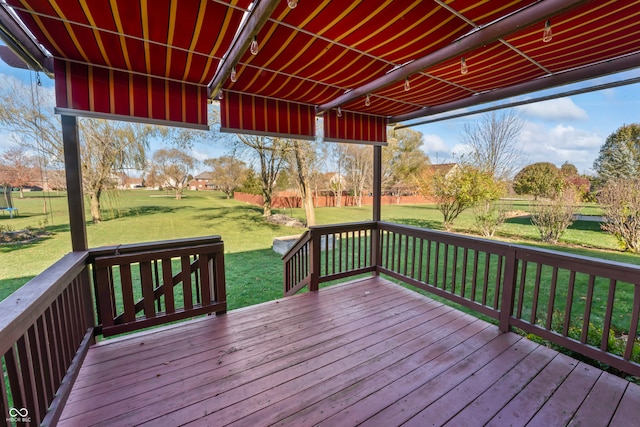 wooden terrace with a lawn