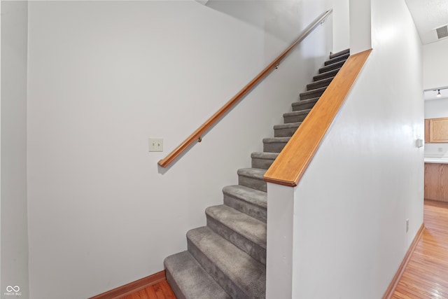 stairway featuring hardwood / wood-style flooring