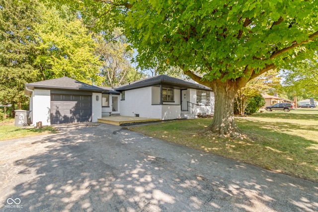 view of front of house with a front lawn and a garage