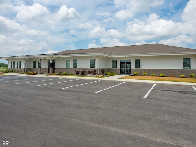 view of building exterior with uncovered parking