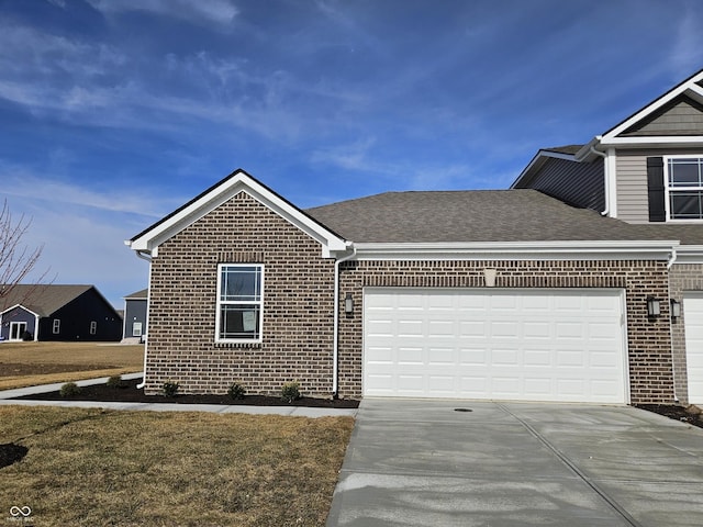 view of front of home with a garage and a front lawn