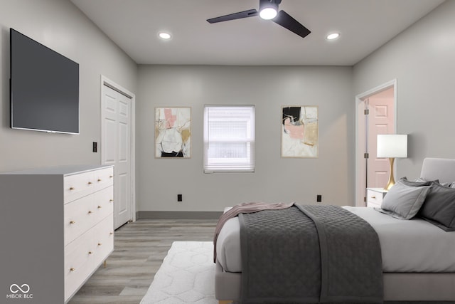 bedroom with light hardwood / wood-style floors and ceiling fan