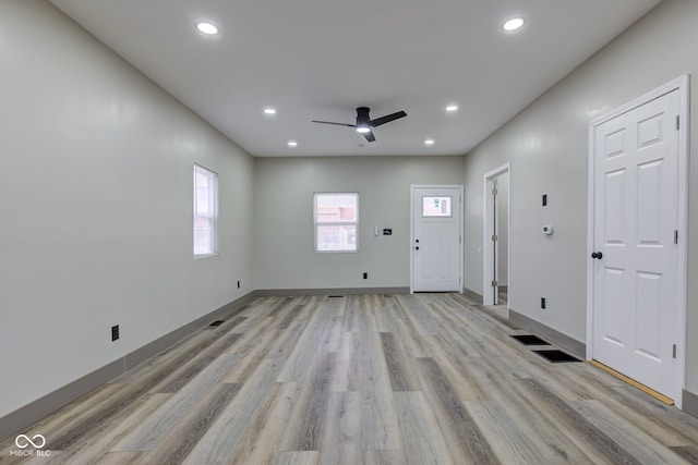 interior space with ceiling fan and light hardwood / wood-style flooring