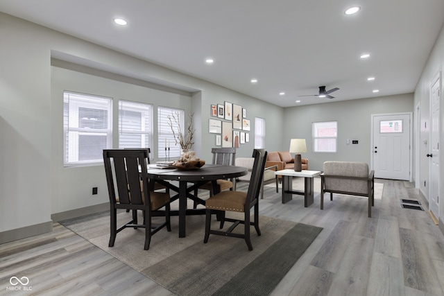 dining area with ceiling fan and light wood-type flooring