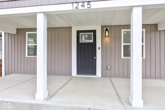 view of exterior entry with covered porch