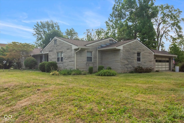 view of front of property with a front yard and a garage