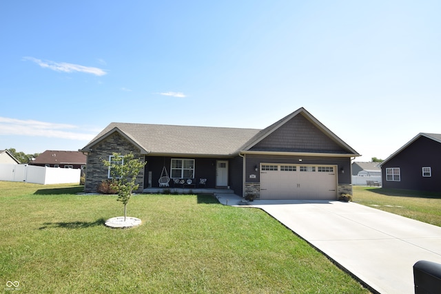 view of front of property with a front yard and a garage