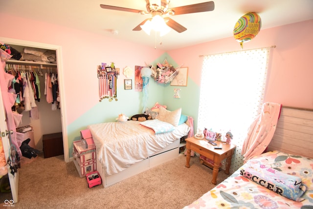 carpeted bedroom featuring ceiling fan and a closet