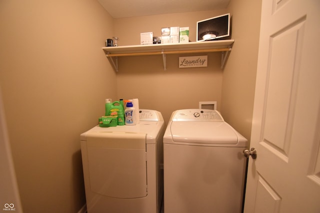 laundry area featuring a textured ceiling and separate washer and dryer