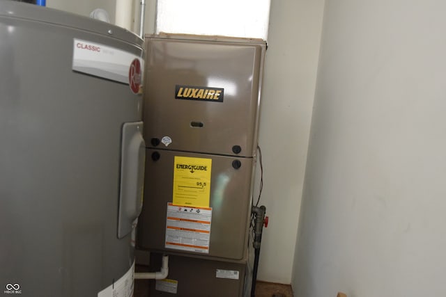 utility room featuring heating unit and washer / dryer