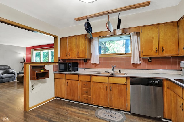 kitchen with a wealth of natural light, backsplash, and stainless steel dishwasher