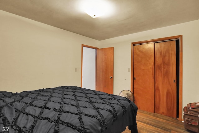 bedroom with wood-type flooring and a closet