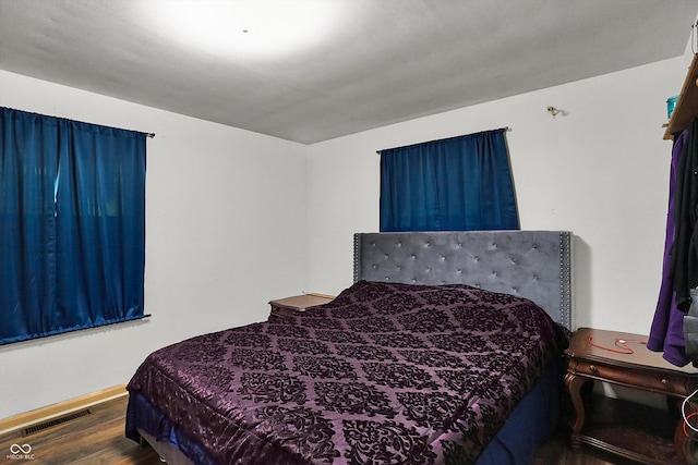 bedroom with hardwood / wood-style flooring