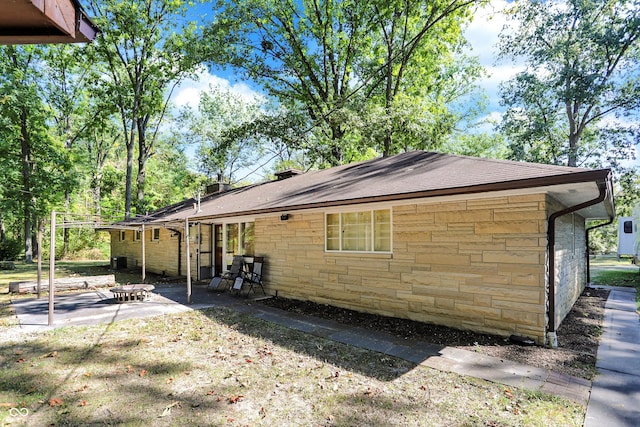 view of side of property featuring a patio