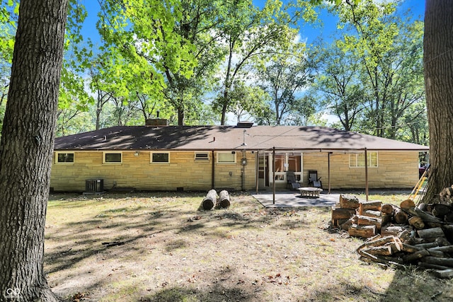 back of property featuring cooling unit and a patio area