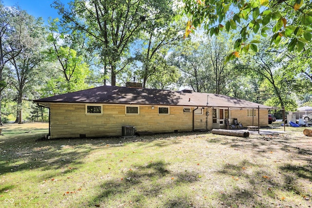 back of house with a yard, a patio area, and central air condition unit