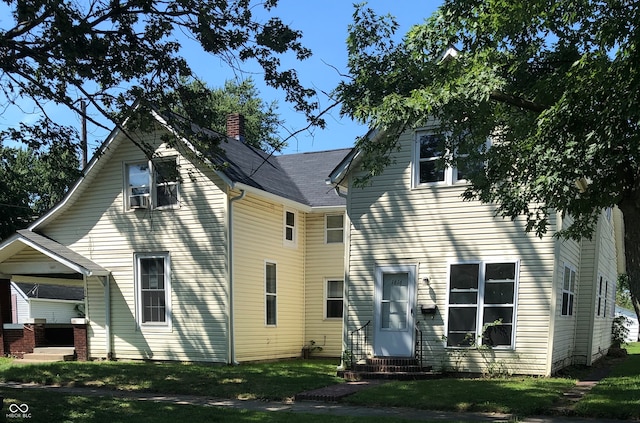 view of front of house featuring a front yard and cooling unit