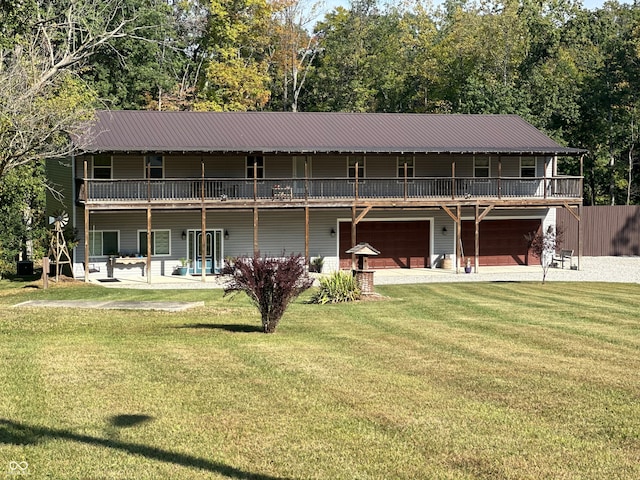 rear view of property featuring a yard and a garage