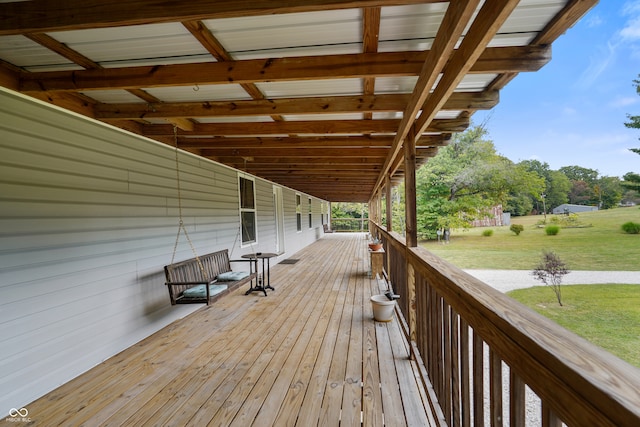 wooden deck featuring a lawn