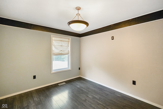 unfurnished room with dark wood-type flooring