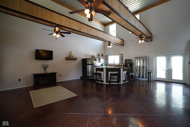 unfurnished living room featuring beamed ceiling, high vaulted ceiling, and wood ceiling