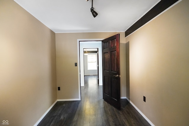 hall with crown molding and dark wood-type flooring