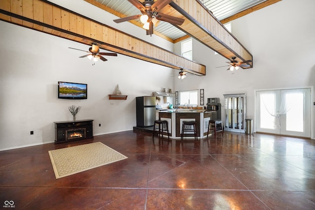 living room with beamed ceiling, wood ceiling, and high vaulted ceiling