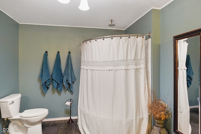 bathroom featuring a shower with curtain, crown molding, hardwood / wood-style floors, and toilet