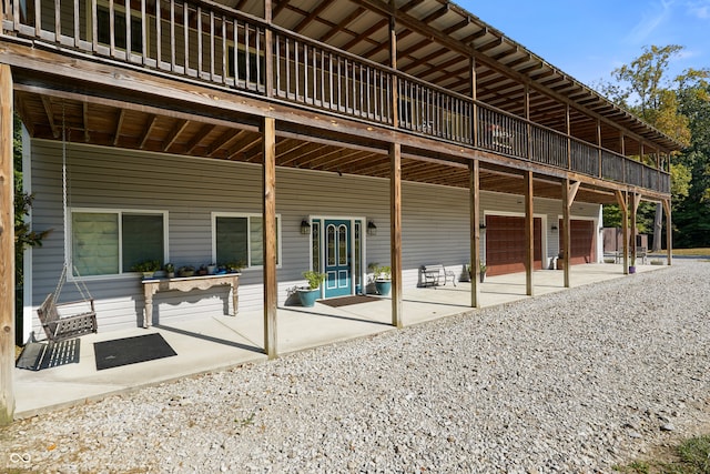 rear view of property featuring a garage