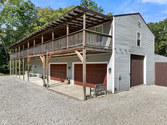 view of front of home featuring a patio and a garage