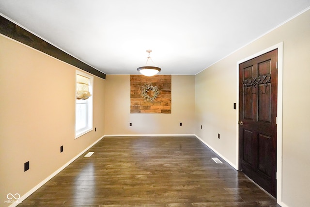 unfurnished room with dark wood-type flooring