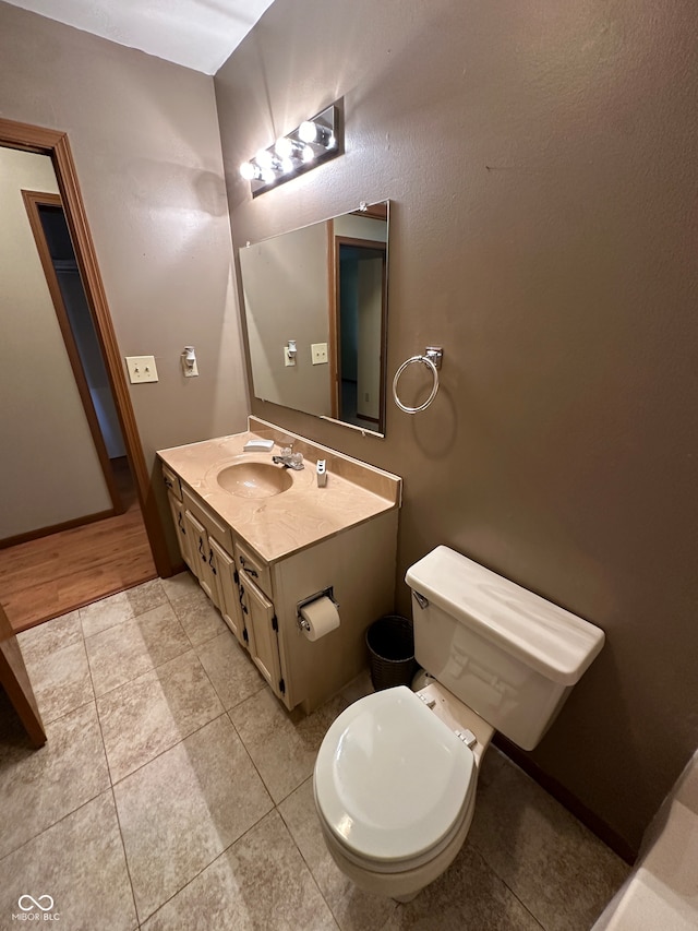 bathroom featuring wood-type flooring, vanity, and toilet