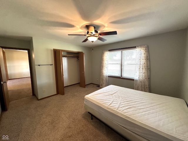 carpeted bedroom featuring a closet and ceiling fan